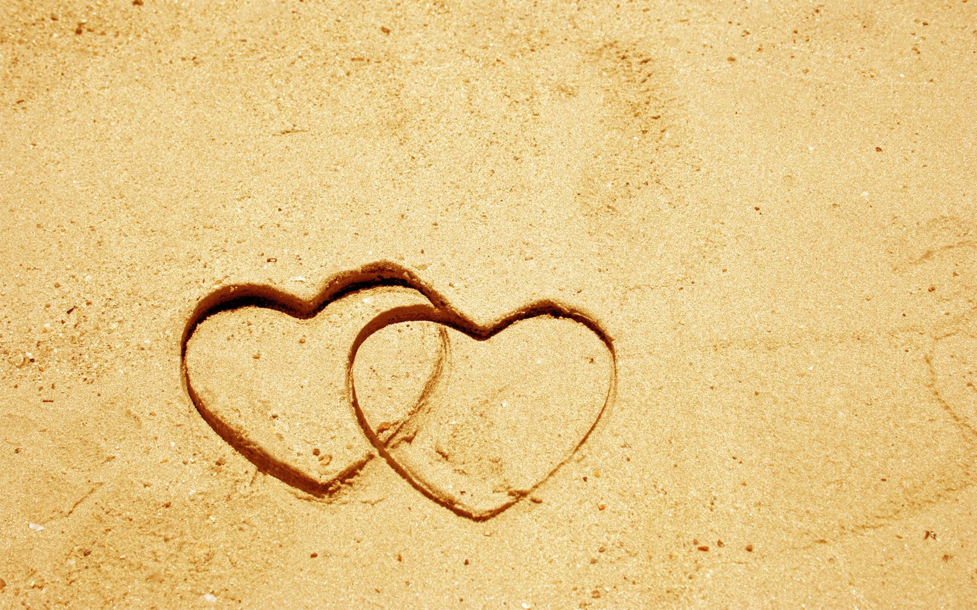 Обои на стол любовь. Фон сердечки. Фон любовь. Обои с сердечками. Сердце на песке.